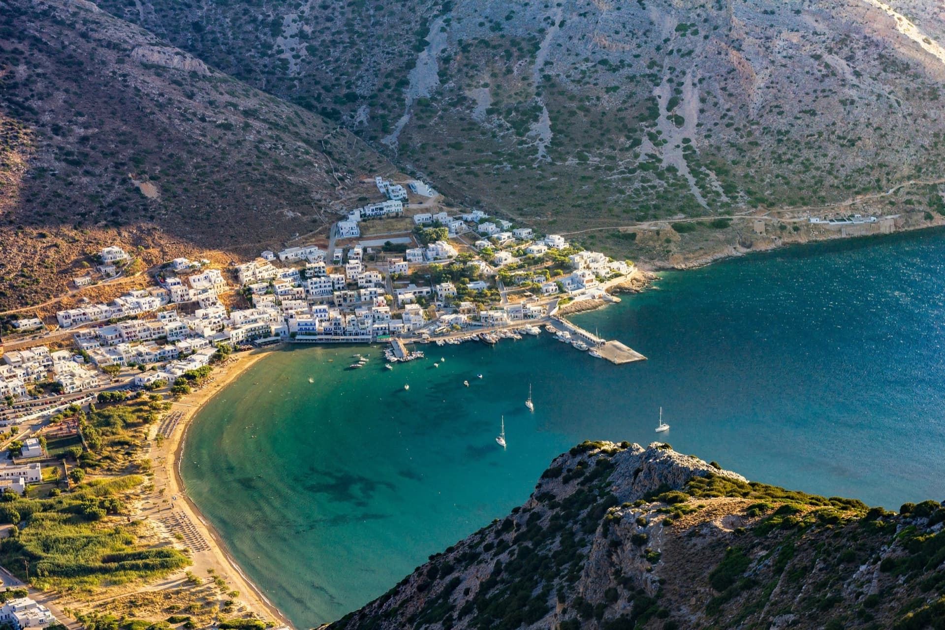 Kamares bay and port on Sifnos seen from above, turquoise water and white houses