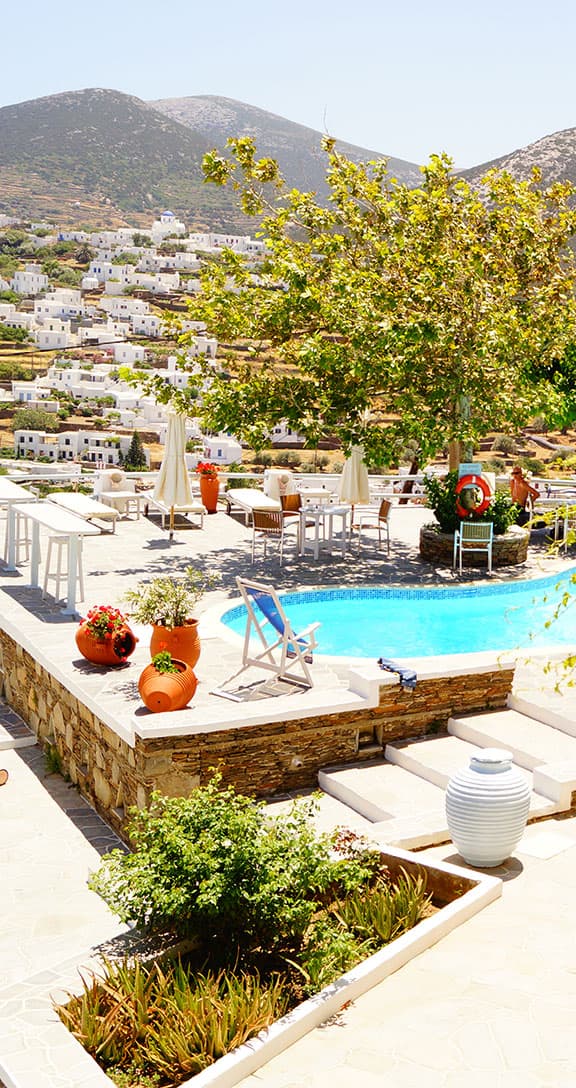 The hotel pool terrace with the villages of Apollonia and the hills behind